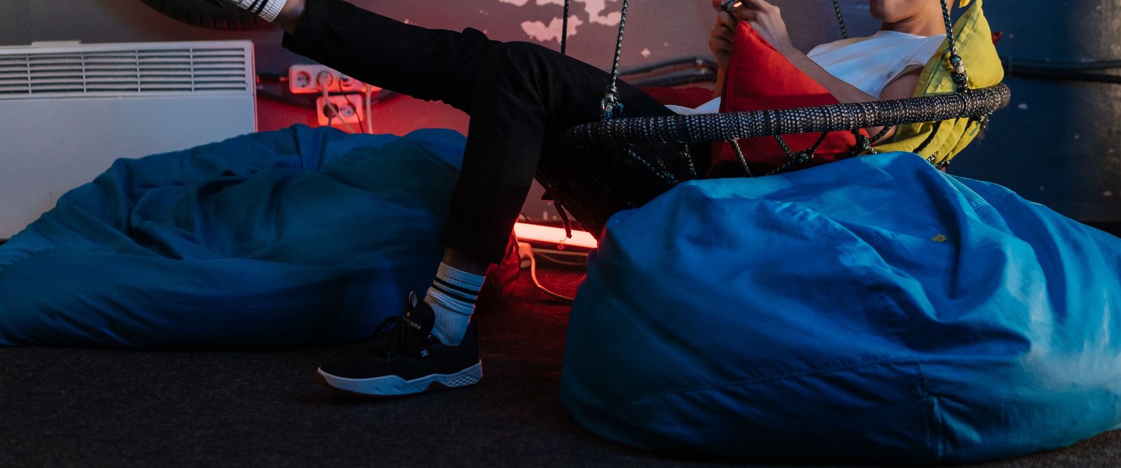 Kicking back on blue bean bags with colourful ambient lighting