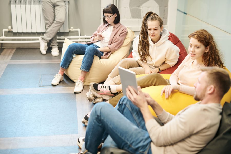 Friends relaxing together on bean bags at an event