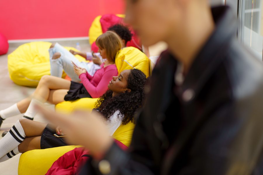 Friends relaxing on bean bags at an event in Perth