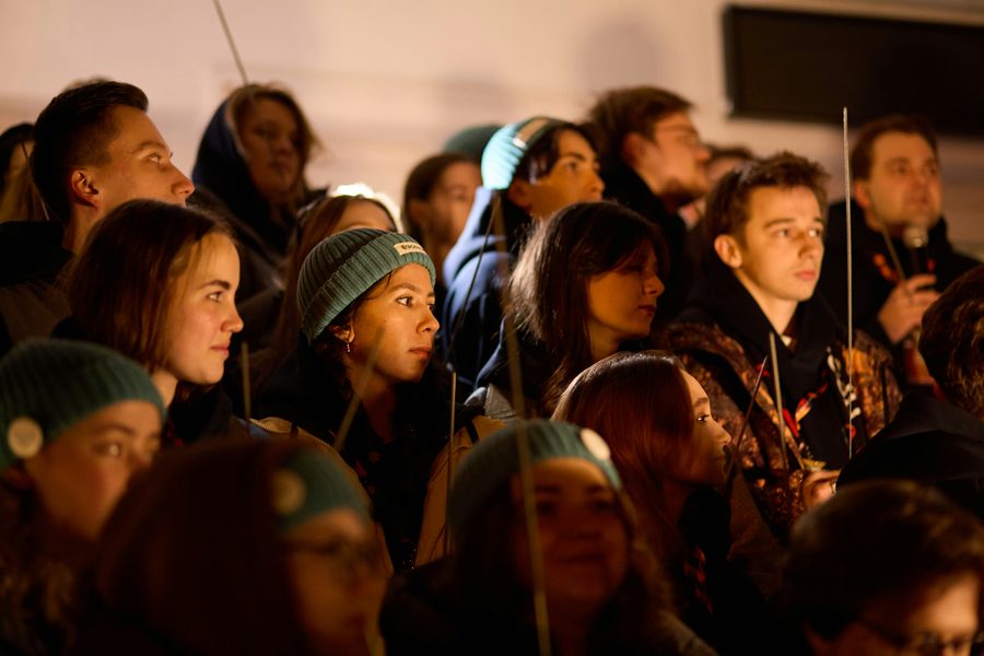 A crowd watching intently at an evening event