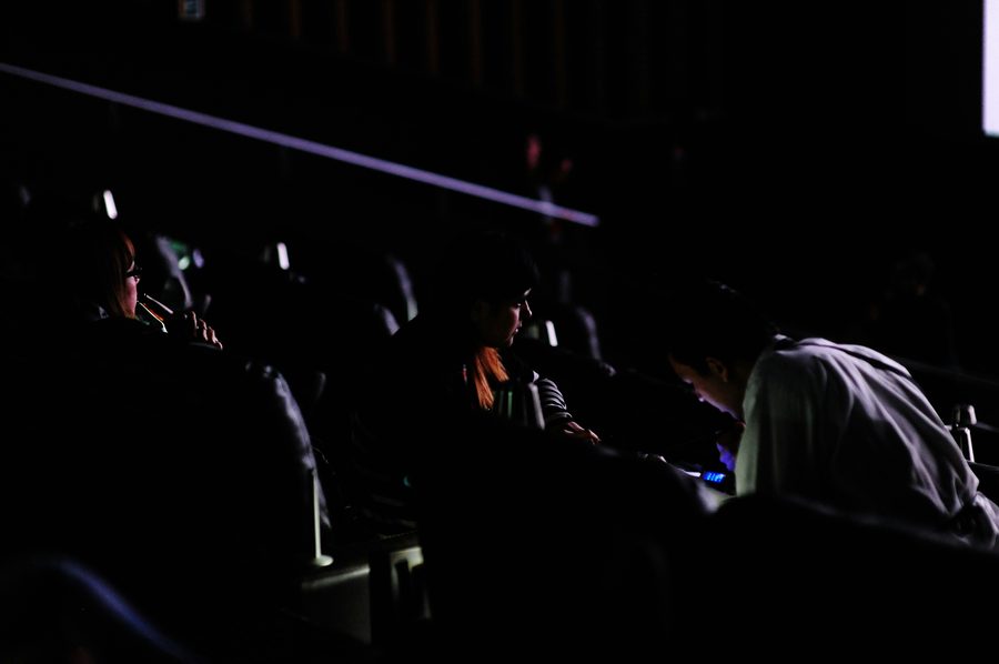 Audience seated in a cinema watching the screen