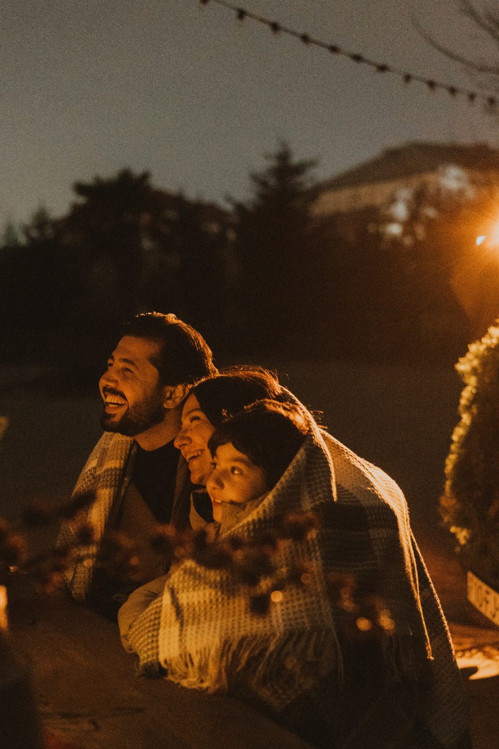 Friends laughing together at an evening event